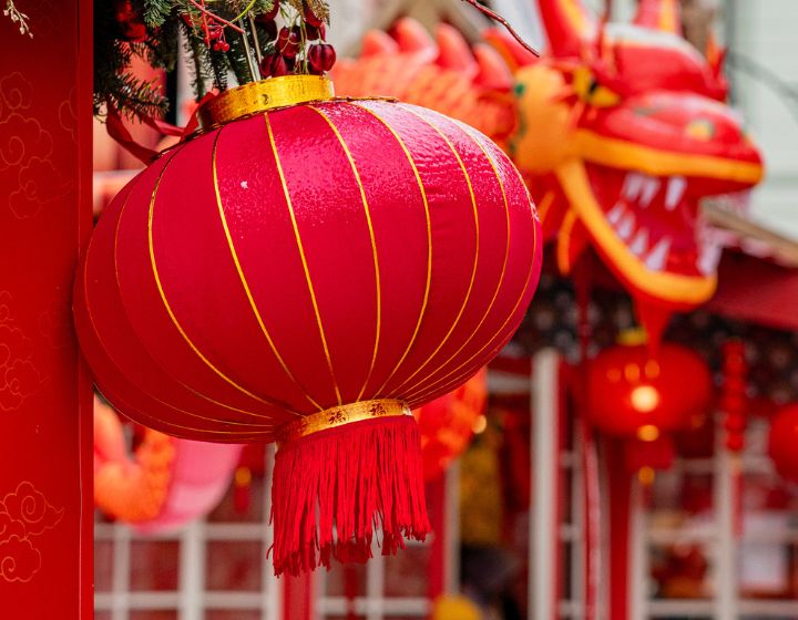 Colorful lanterns and dragon decorations adorn festive street during Chinese New Year celebration