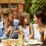 Family enjoying a vegetarian pizza! Check out these Vegetarian Restaurants across Hong Kong!